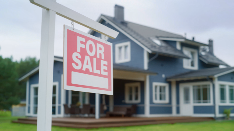 For Sale Sign in front of house