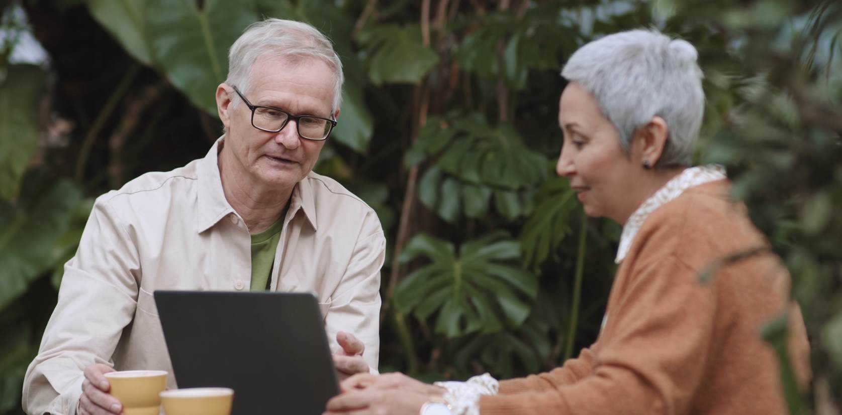 old couple discussing ipad